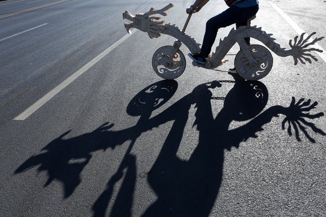 Sun Chao rides on a dragon-shaped bicycle he made with ice-cream sticks, in Tieling, Liaoning province, China October 15, 2018. Picture taken October 15, 2018. REUTERS/Stringer  ATTENTION EDITORS - THIS IMAGE WAS PROVIDED BY A THIRD PARTY. CHINA OUT.     