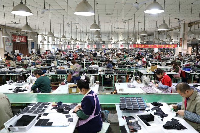 Employees work on the production line of a factory manufacturing fashion accessories in Sihong county, Jiangsu province, China March 27, 2019. Picture taken March 27, 2019. REUTERS/Stringer  ATTENTION EDITORS - THIS IMAGE WAS PROVIDED BY A THIRD PARTY. CH