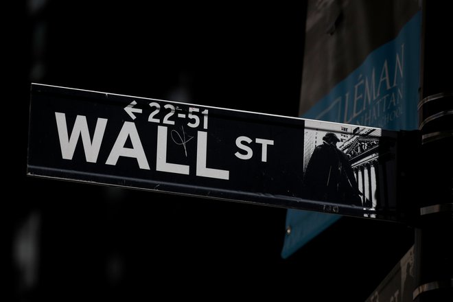 A Wall St. street sign is seen near the New York Stock Exchange (NYSE) in New York City, U.S., September 17, 2019. REUTERS/Brendan McDermid - RC15DB6D8D60