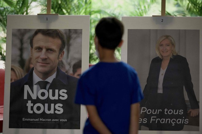 Sliki kandidatov Emmanuela Macrona (L) in Marine Le Pen (D). Foto: Noel Celis / AFP

